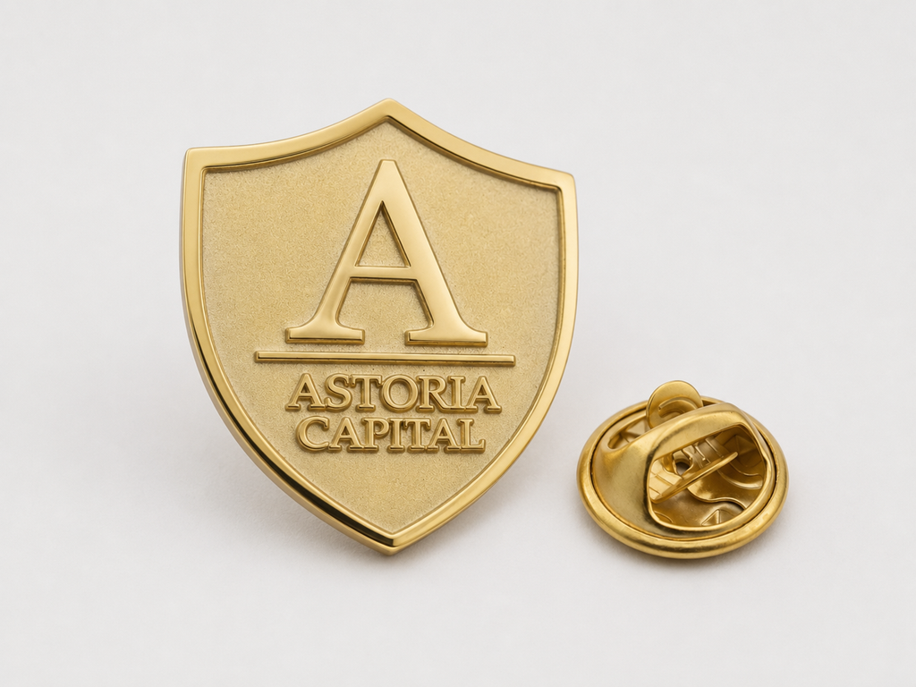 Custom brass shield lapel pin sample with gold-tone finish and butterfly clutch